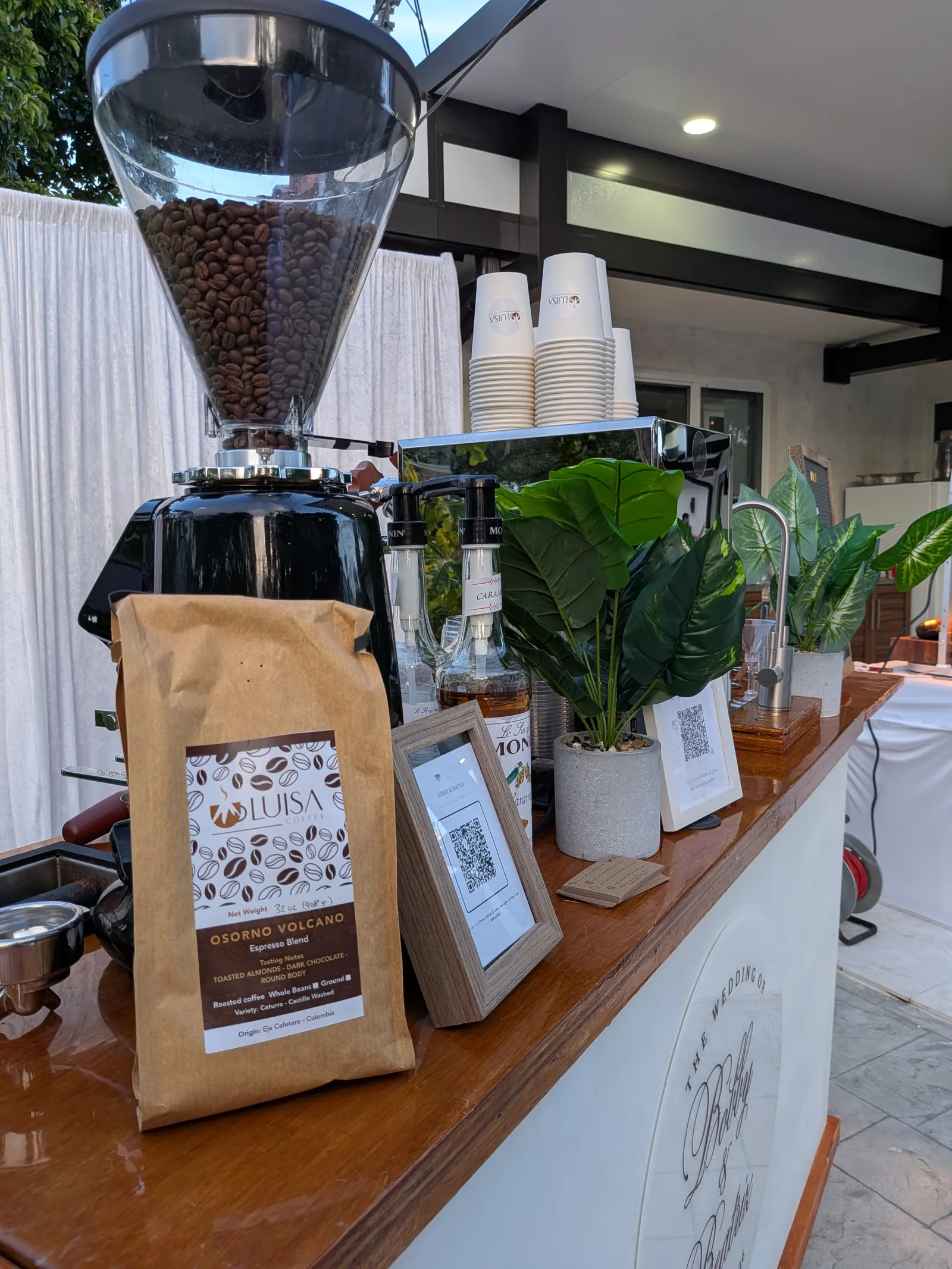 Coffee cart set up for an outdoor garden wedding reception at dusk