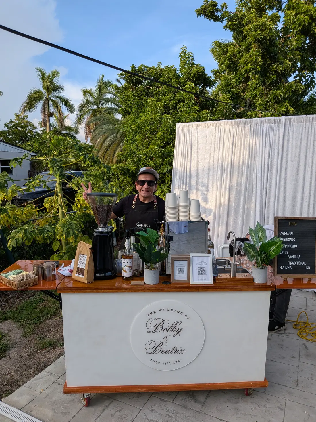Miami Coffee Cart barista at a custom-branded cart reading 'The Wedding of Bobby & Beatriz', captured live through Luisa Moments